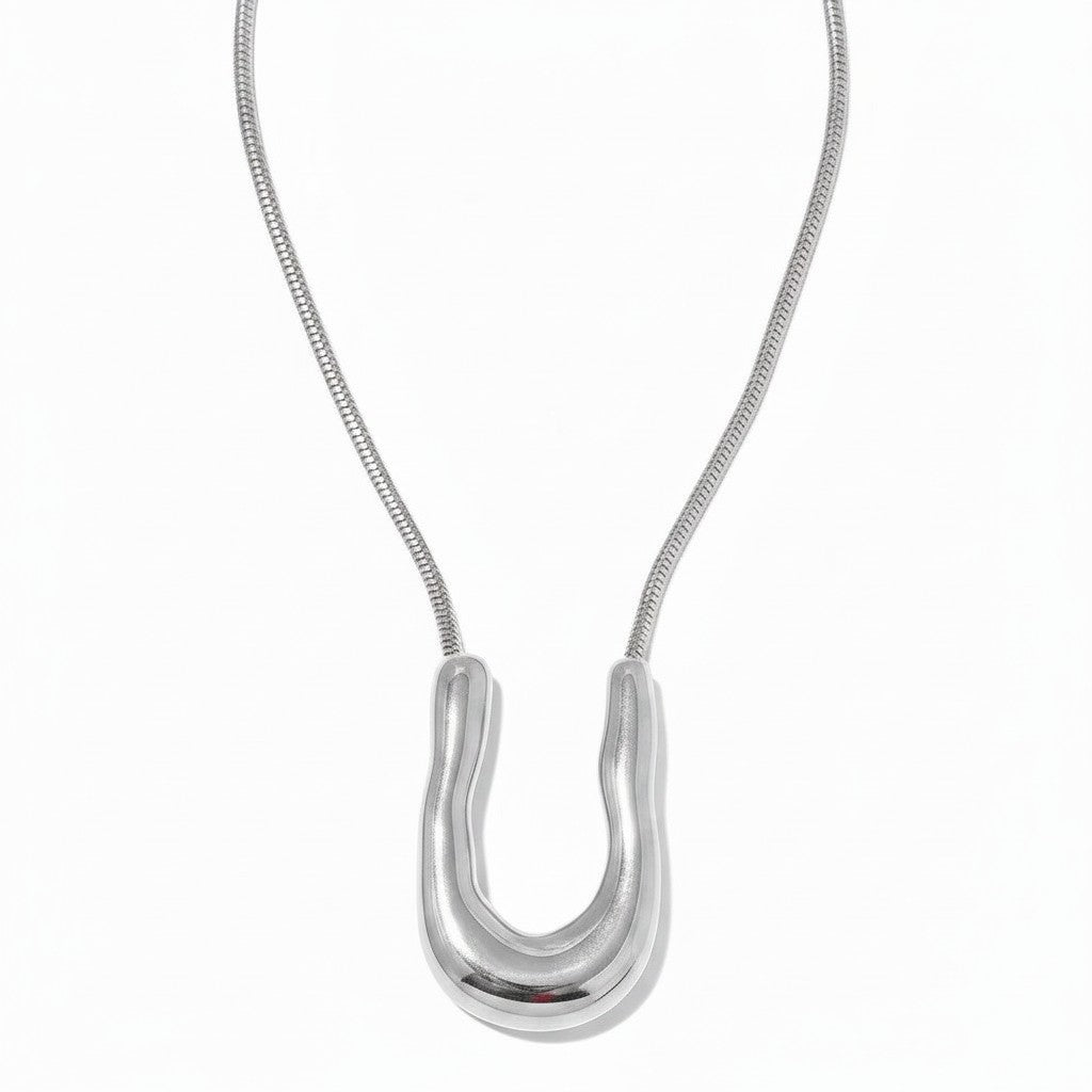 PRO RAY ELORA silver sculptural pendant necklace with organic curves and snake chain. 40mm pendant.