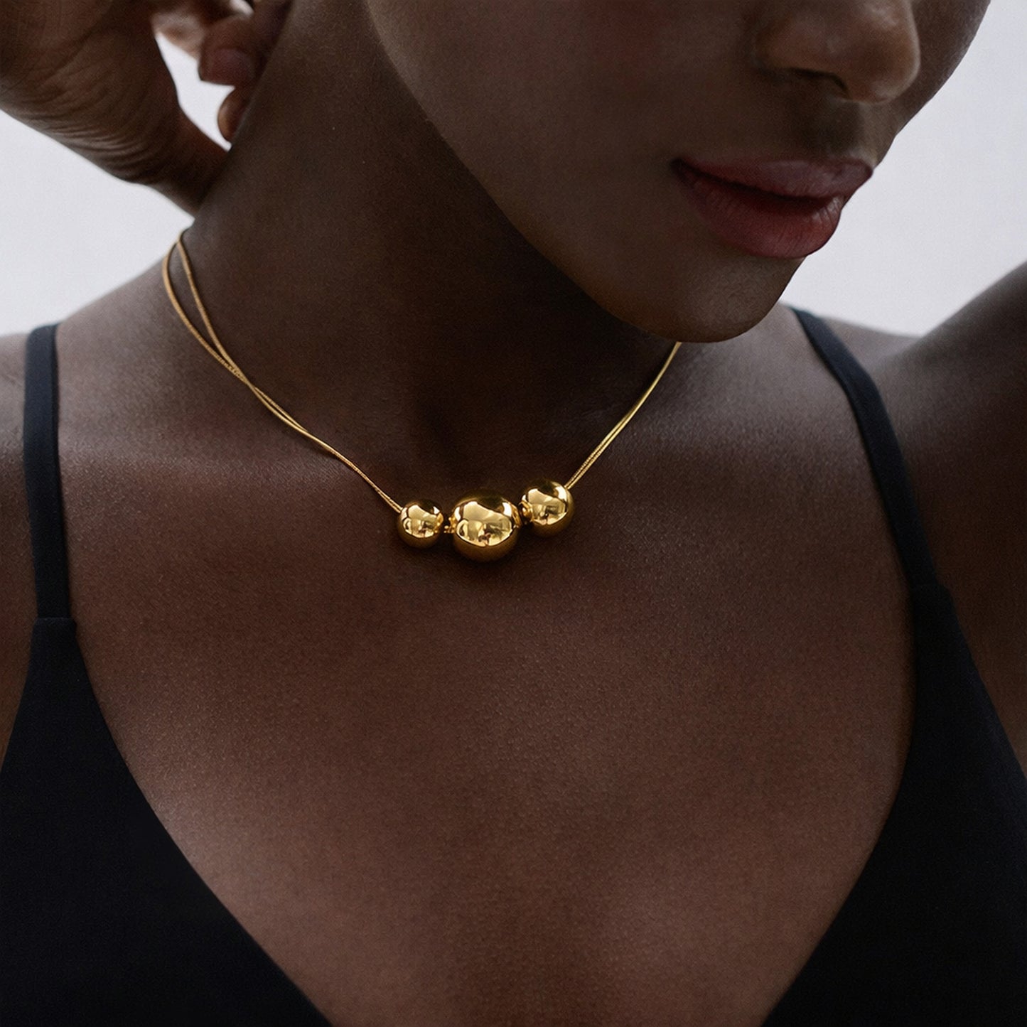 PRO RAY NOVA gold necklace close up on model minimalist bead necklace