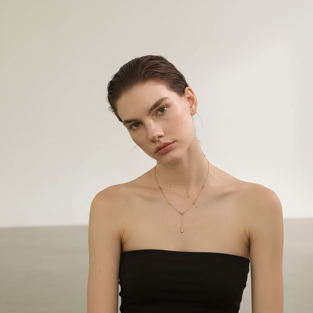 PRO RAY AIRA gold-tone necklace with drop-inspired accents, 43cm chain length.