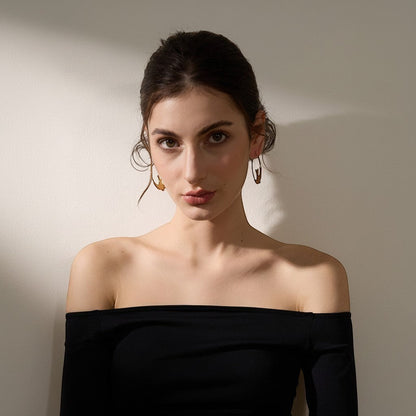 PRO RAY ALYRA gold hoop earrings with sculptural swallow design, 44mm diameter.