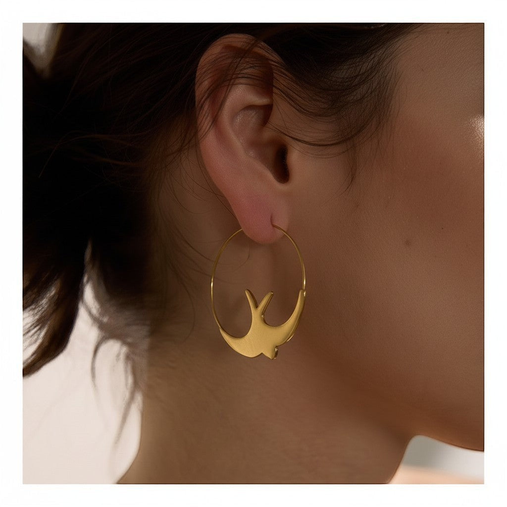 PRO RAY gold hoop earrings with sculptural swallow design, 44mm diameter, elegant statement jewelry.
