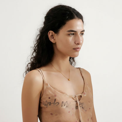 PRO RAY AVAYA delicate gold star pendant necklace on a 42cm chain, worn by a model.
