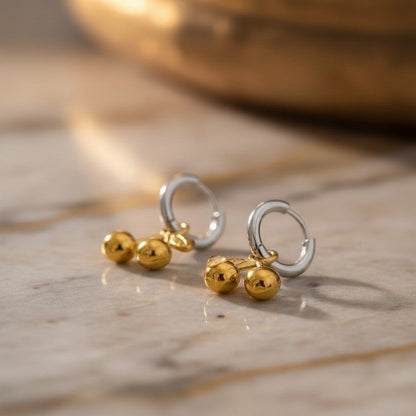 PRO RAY CERISE Hoops: Elegant silver hoops with gold cherry drop details. Playful yet sophisticated earrings.