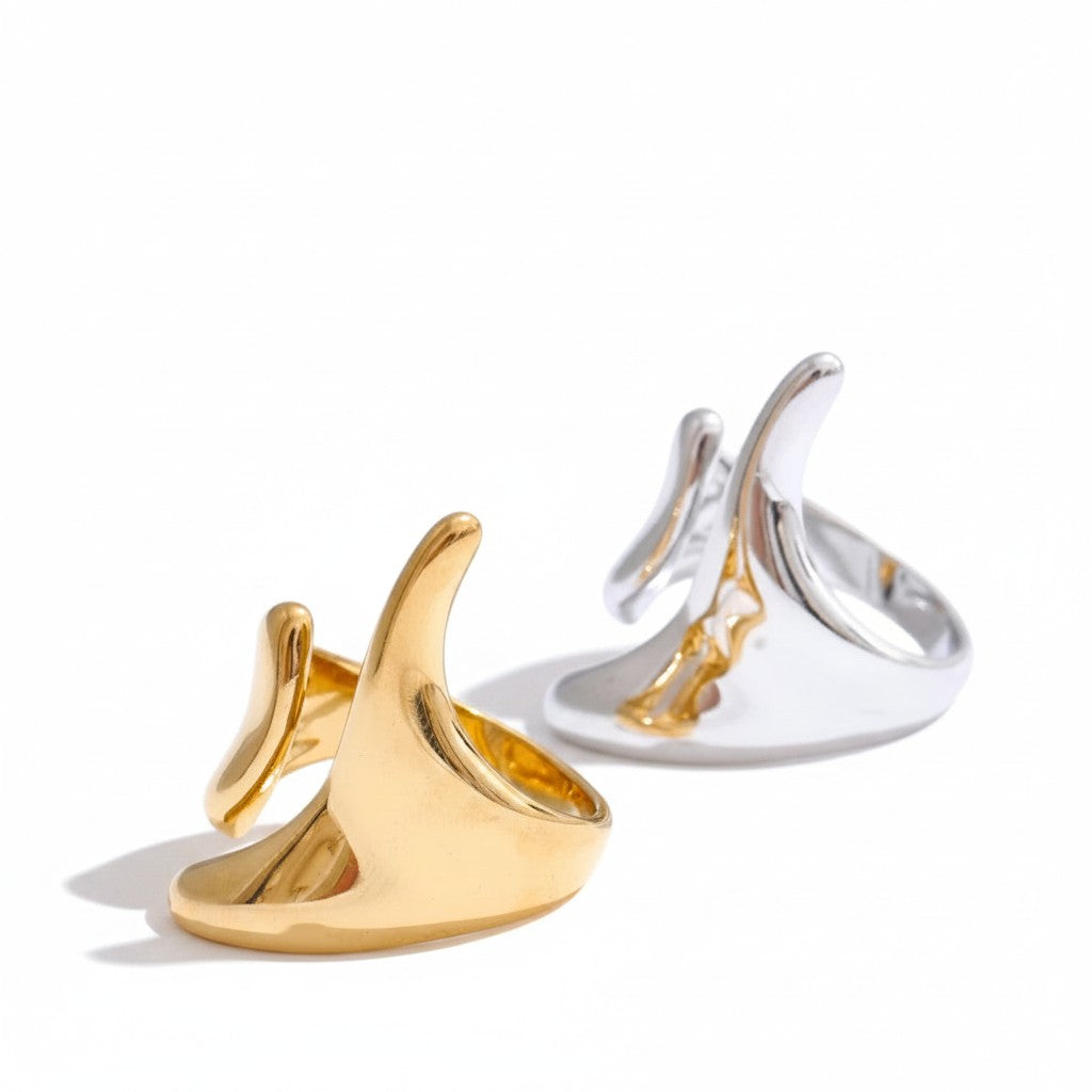 PRO RAY ELISIA sculptural open ring with asymmetrical curved lines in gold and silver finishes.