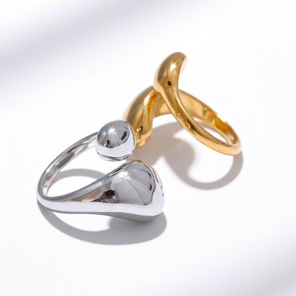 PRO RAY ELORIA ring with a sculptural open design, smooth organic curves, and a bold polished silhouette in gold and silver.