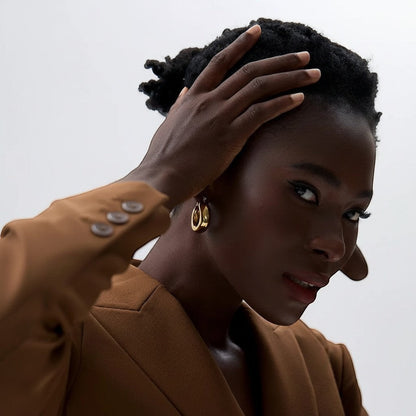 PRO RAY SOREYA sculptural gold-tone metal hoop earrings with smooth curved form, 30mm diameter.