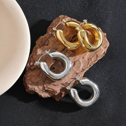 PRO RAY SOREYA sculptural gold and silver hoop earrings with smooth curved form, 30mm diameter.