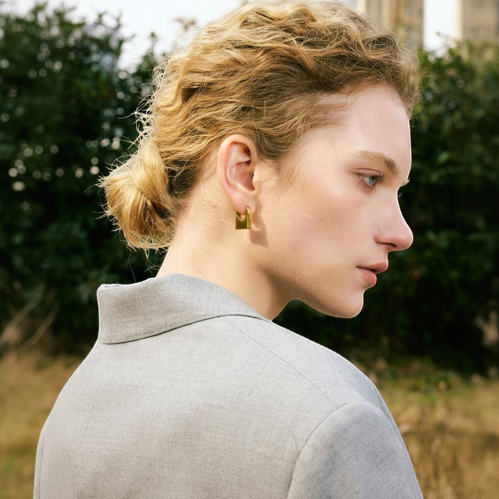 PRO RAY KAIA sculptural rectangular gold hoop earrings with polished finish. Architectural silhouette.