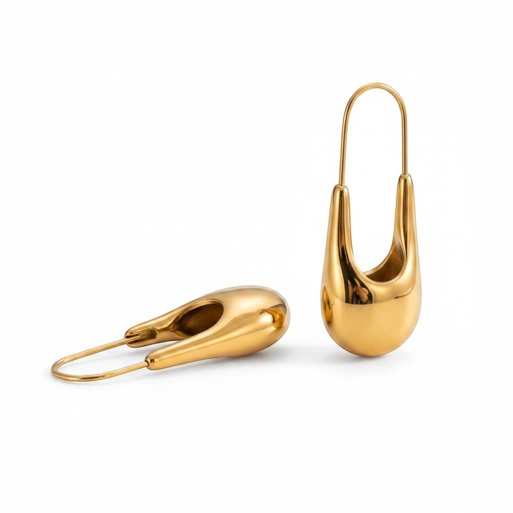 PRO RAY NYRA Hoops: Sculptural gold drop earrings with a fluid, elongated silhouette and polished finish.