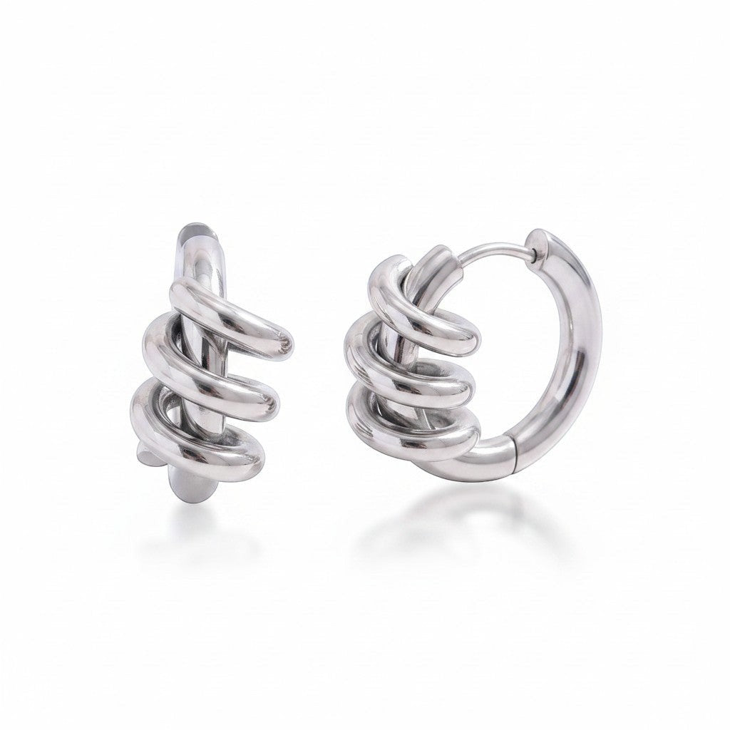 PRO RAY SELENE sculptural spiral hoop earrings in polished silver, 22mm diameter.