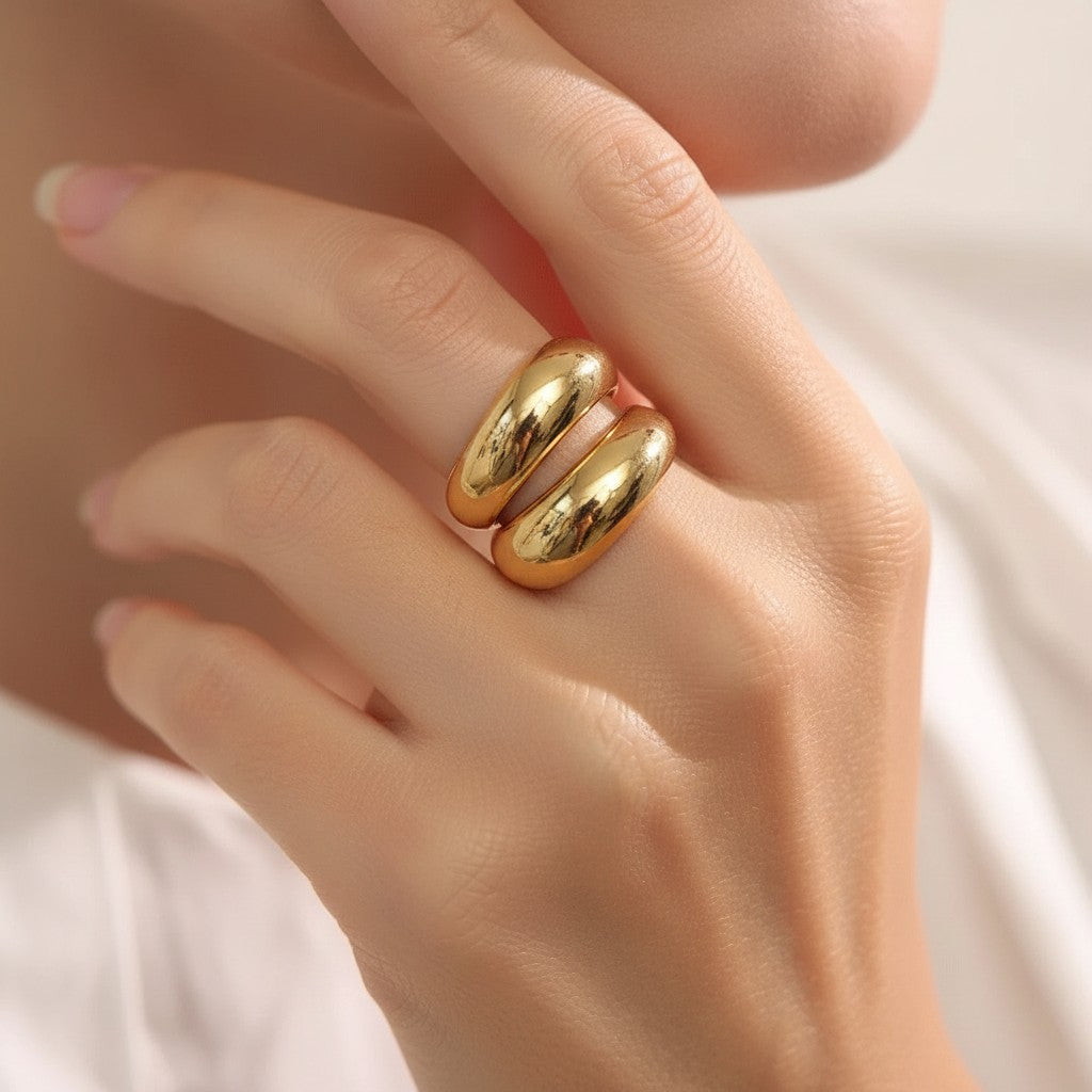 PRO RAY SERAVIA Ring: A bold, polished gold sculptural ring with flowing curved lines and an open silhouette.