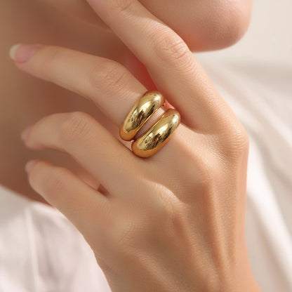 PRO RAY SERAVIA Ring: A bold, polished gold sculptural ring with flowing curved lines and an open silhouette.
