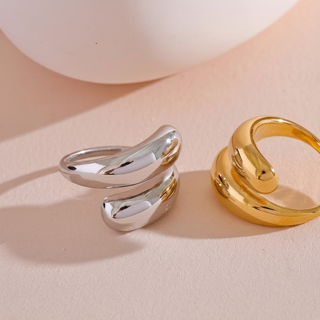 PRO RAY SERAVIA ring with flowing curved lines, smooth polished finish, open silhouette in silver and gold.