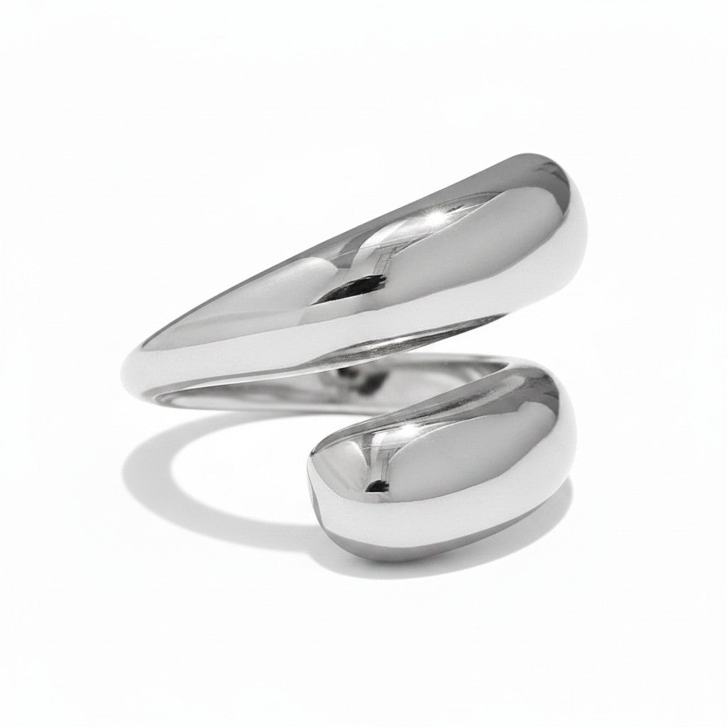 PRO RAY SERAVIA sculptural silver ring with flowing curved lines and a smooth polished finish. Modern minimalist open silhouette.