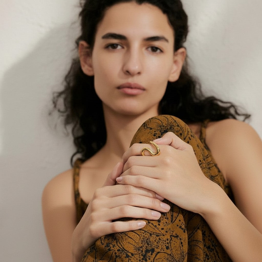 PRO RAY SORELLE sculptural open ring with fluid curved lines in gold-tone metal.