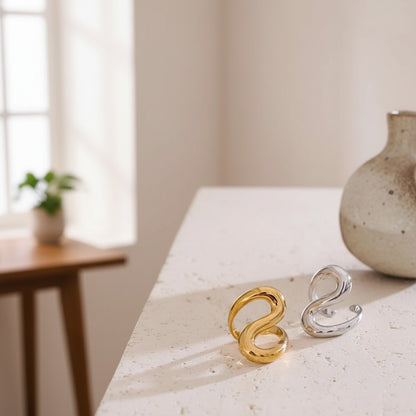 PRO RAY SORELLE open ring in gold and silver finishes with sculptural curved lines and a modern silhouette.