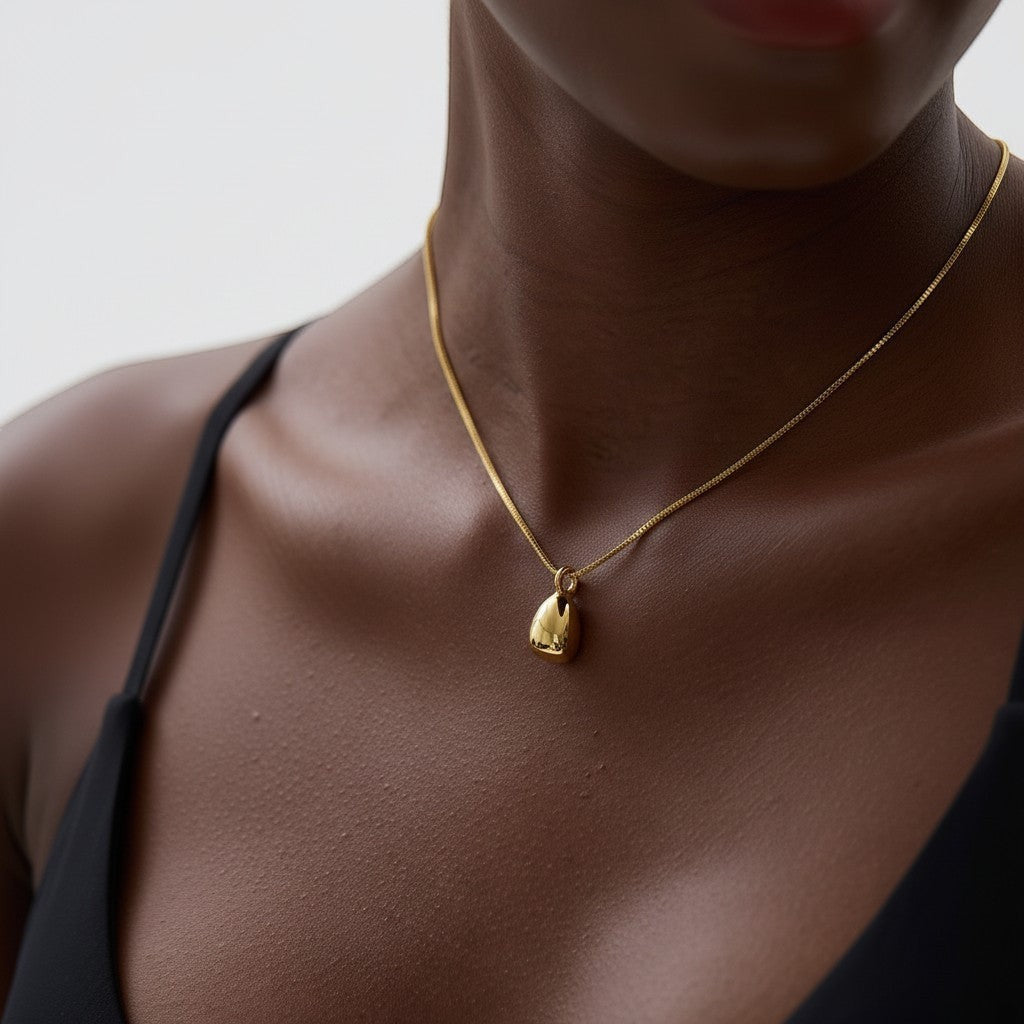 PRO RAY TELYA sculptural gold pendant necklace with soft flowing curves on a delicate chain.