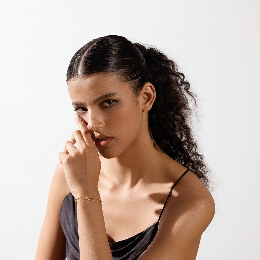 PRO RAY VELISSA layered gold bracelet with fine bead detailing and fluid chain on a model.