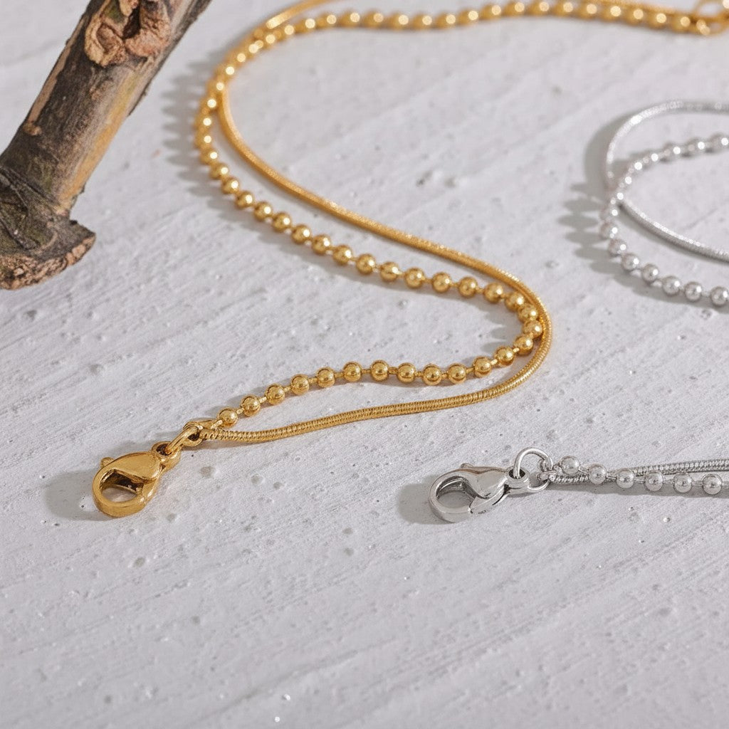 PRO RAY VELISSA layered bracelet in gold and silver, featuring fine bead detailing and a sleek fluid chain.
