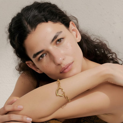 PRO RAY VELORA sculptural gold heart chain bracelet on a woman's wrist, modern statement jewelry