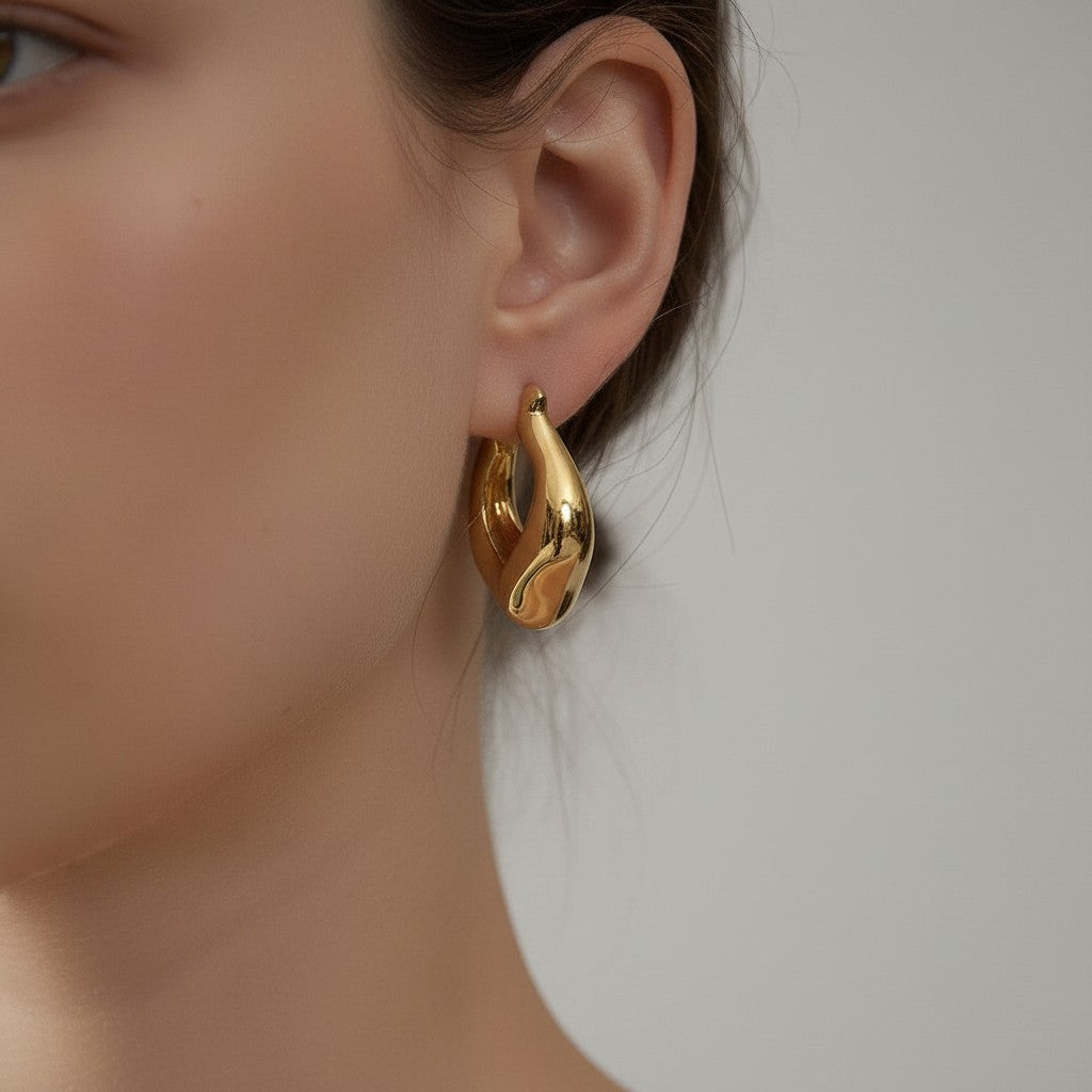 PRO RAY VIONA sculptural gold hoop earrings with a fluid organic shape and polished finish.