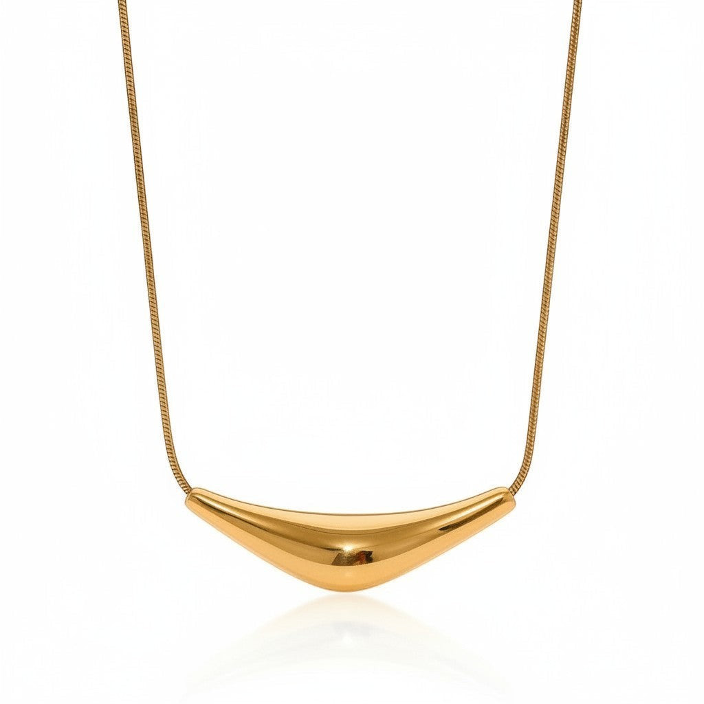 PRO RAY VIRA necklace with a fluid sculptural gold pendant on a snake chain. Perfect for day or evening wear.