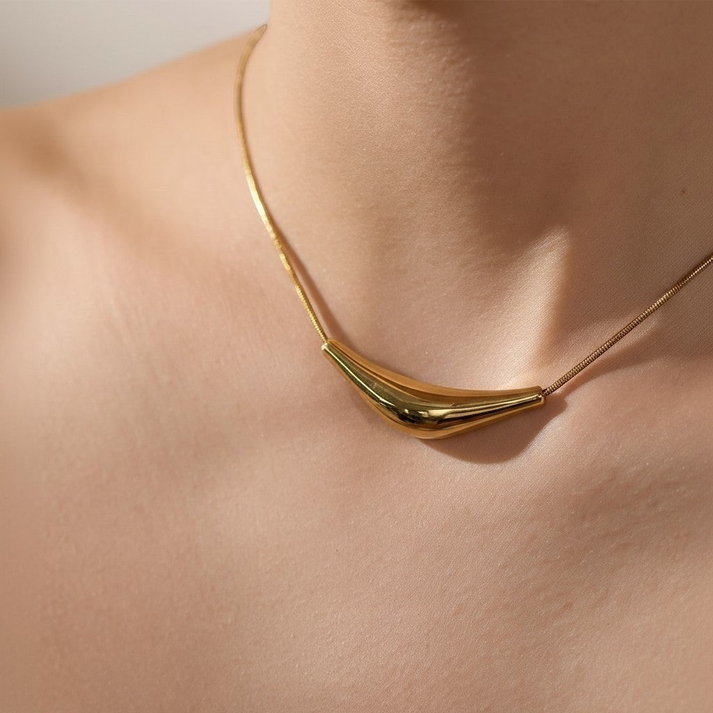 PRO RAY VIRA gold sculptural statement necklace with fluid design, 45mm pendant, 40cm chain.