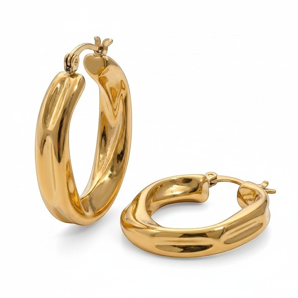 PRO RAY Zaria gold twisted hoop earrings with a sculptural silhouette, 31mm diameter.